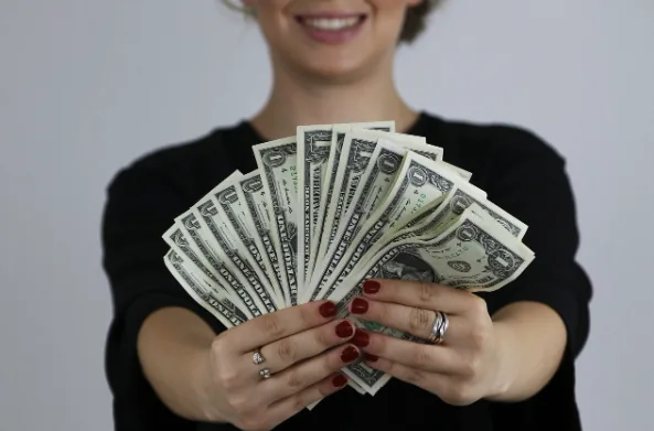 Person holding a fan of banknotes